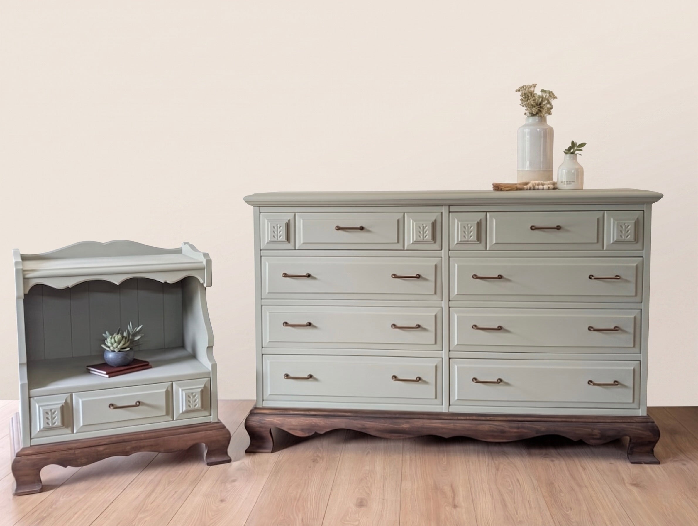 Two pieces of restored furniture, a small cabinet and a larger dresser, on a wooden floor with a plain background.